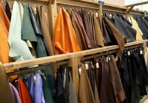 Various colored leather hides displayed in a retail store