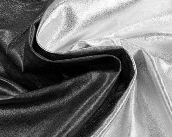 Wrinkled metallic grey and silver shiny fabric or nappa leather.