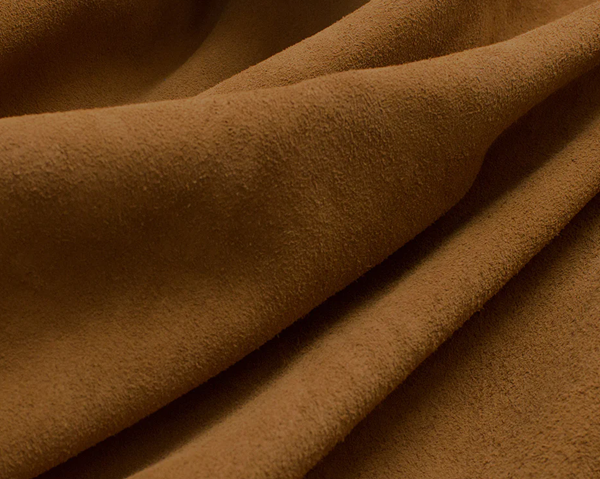Close-up of soft, textured brown suede or nubuck leather fabric.